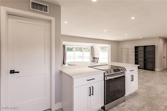 kitchen with visible vents, white cabinets, light countertops, stainless steel range with electric stovetop, and recessed lighting