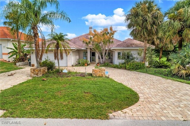 mediterranean / spanish-style house featuring a front yard