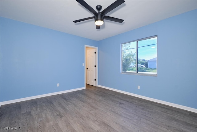 spare room with ceiling fan and dark hardwood / wood-style floors