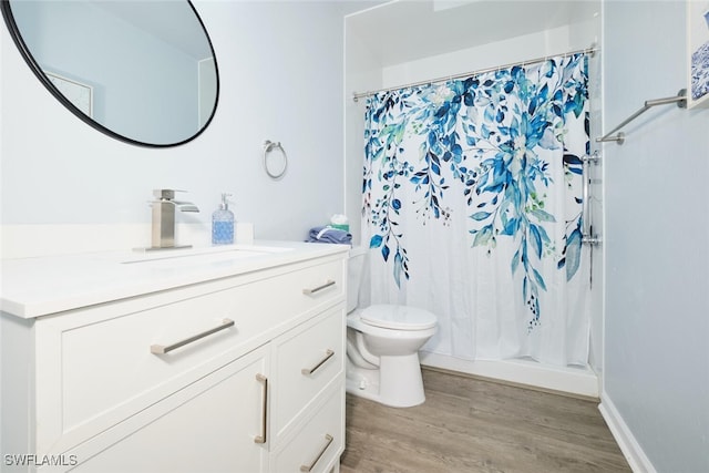 full bathroom featuring hardwood / wood-style flooring, vanity, toilet, and shower / tub combo