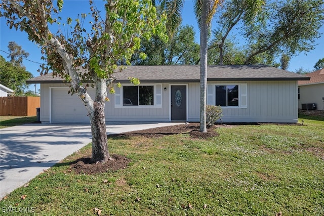 ranch-style home with a garage, central air condition unit, and a front lawn