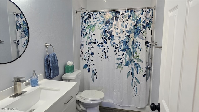 full bathroom with shower / bathtub combination with curtain, vanity, and toilet