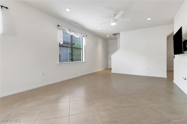 empty room featuring ceiling fan and light tile patterned flooring