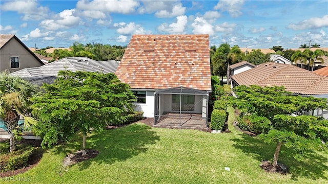 back of property featuring a yard and a patio area