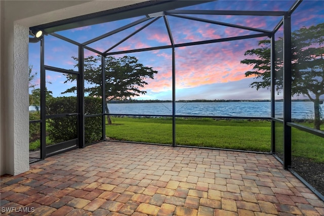 unfurnished sunroom with a water view