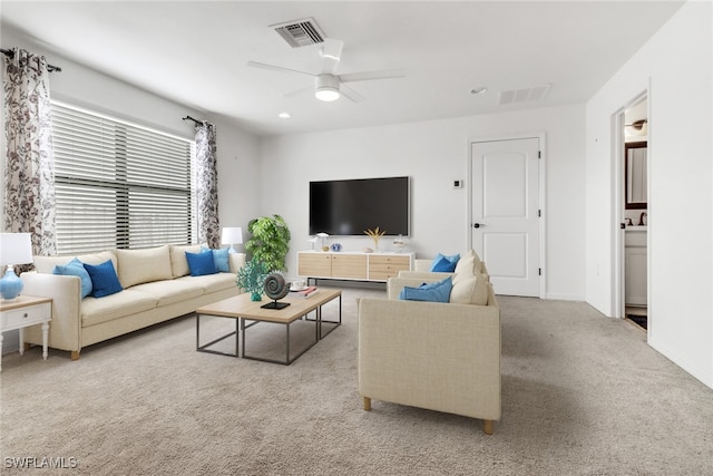 living room with light colored carpet and ceiling fan