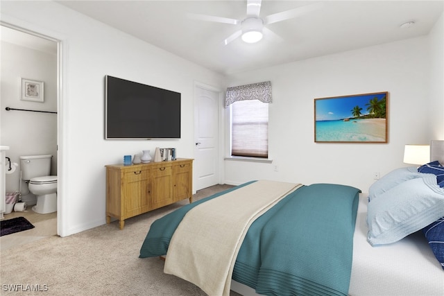 bedroom with ensuite bath, carpet, and ceiling fan