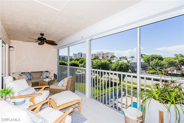 sunroom with a view of city and a ceiling fan