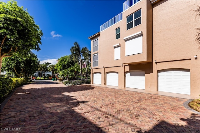 view of property exterior with driveway and stucco siding