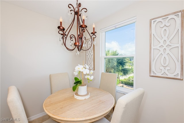 dining room featuring baseboards and a notable chandelier