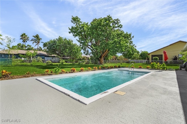 view of swimming pool with a yard and a patio