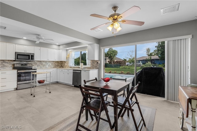 dining area with ceiling fan and light tile patterned floors