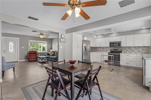 dining room featuring light tile patterned flooring and ceiling fan