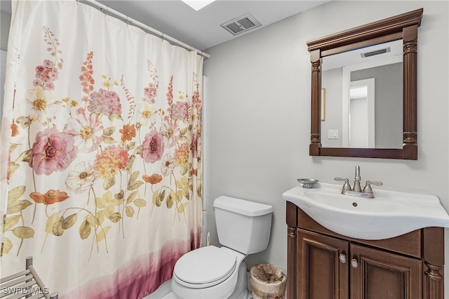 bathroom with vanity, toilet, and curtained shower