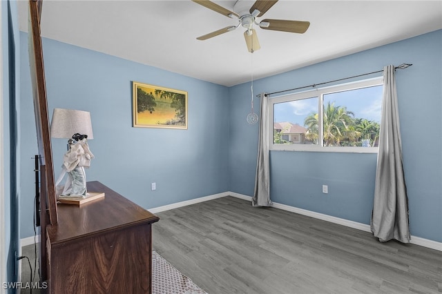 office with dark wood-type flooring and ceiling fan