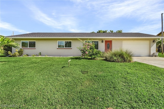 ranch-style house with a garage and a front lawn