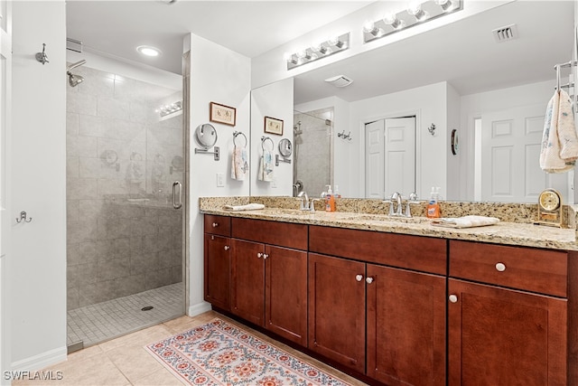 bathroom featuring vanity, walk in shower, and tile patterned flooring