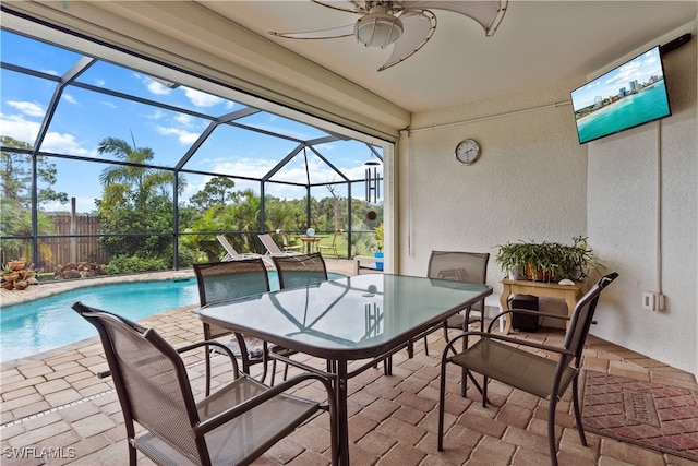 view of patio / terrace featuring glass enclosure and ceiling fan