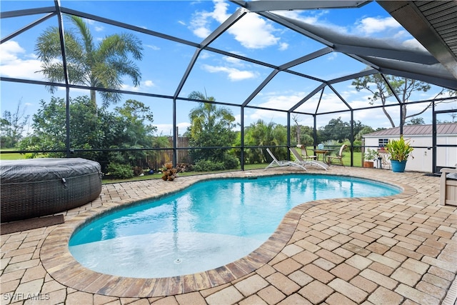 view of swimming pool featuring a patio and a lanai