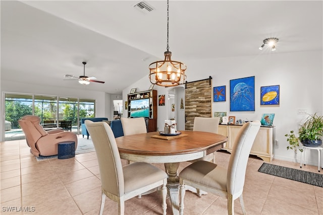 dining space featuring a barn door, light tile patterned flooring, ceiling fan with notable chandelier, and vaulted ceiling