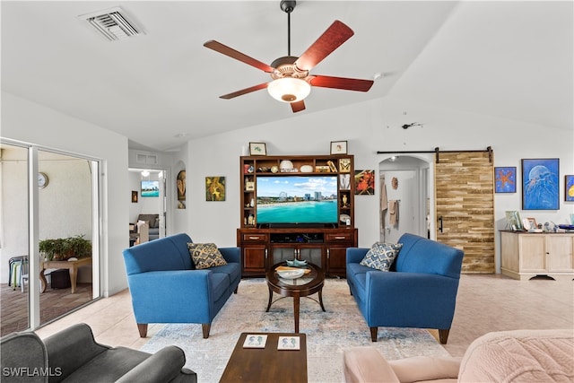 living room with lofted ceiling, wooden walls, a barn door, and ceiling fan