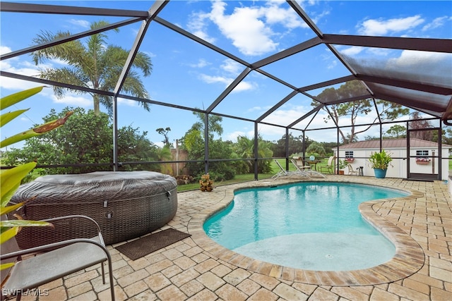 view of swimming pool with a shed, a patio, and a lanai