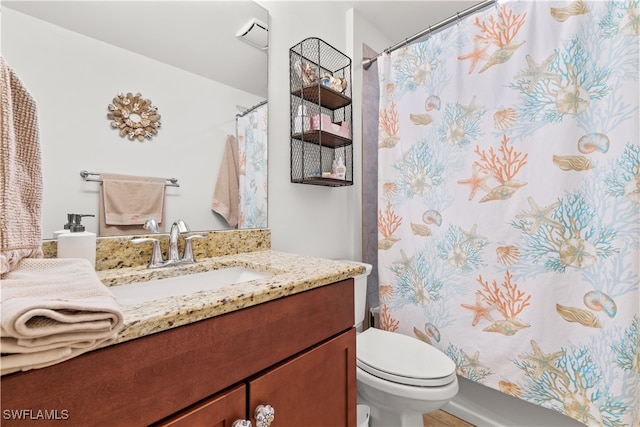 bathroom with vanity, a shower with curtain, and toilet