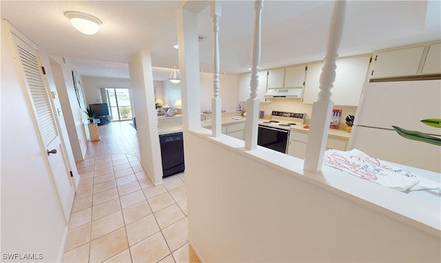 kitchen with white appliances, a textured ceiling, and light tile patterned flooring