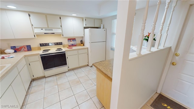 kitchen with light tile patterned floors and white appliances