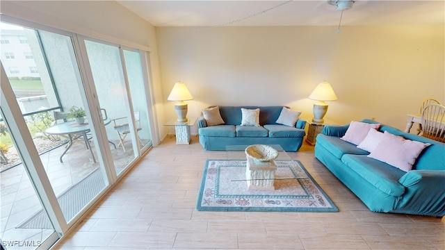 living room featuring a wealth of natural light and ceiling fan