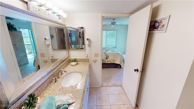 bathroom featuring vanity, a textured ceiling, ceiling fan, and tile patterned flooring