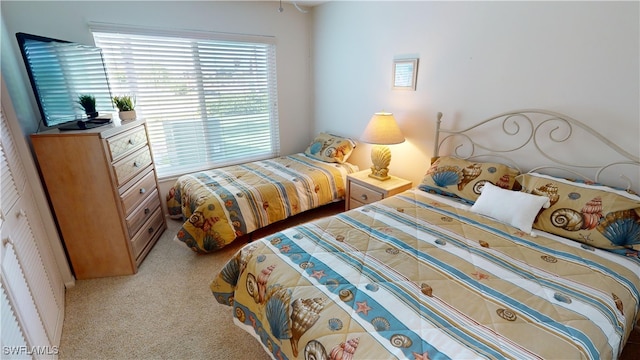 bedroom featuring light colored carpet