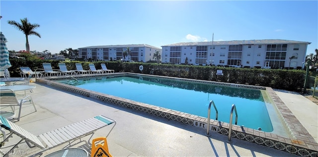 view of swimming pool with a patio