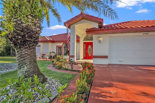 mediterranean / spanish-style home with a garage