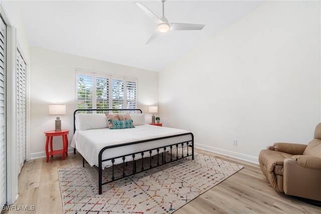 bedroom with vaulted ceiling, ceiling fan, baseboards, and light wood-style floors