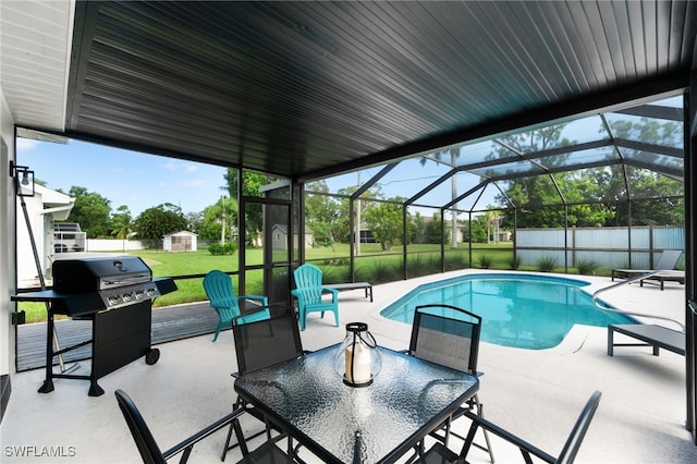 view of swimming pool with a patio area, a grill, a storage shed, and a yard