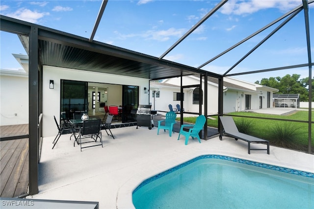 pool with a patio, a lawn, grilling area, and a lanai