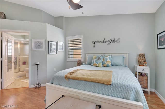 bedroom featuring light hardwood / wood-style flooring, ceiling fan, and ensuite bath