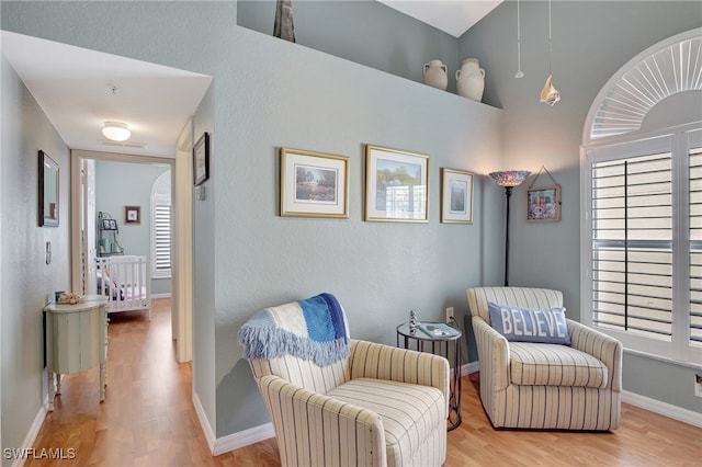 living area with hardwood / wood-style flooring and a healthy amount of sunlight