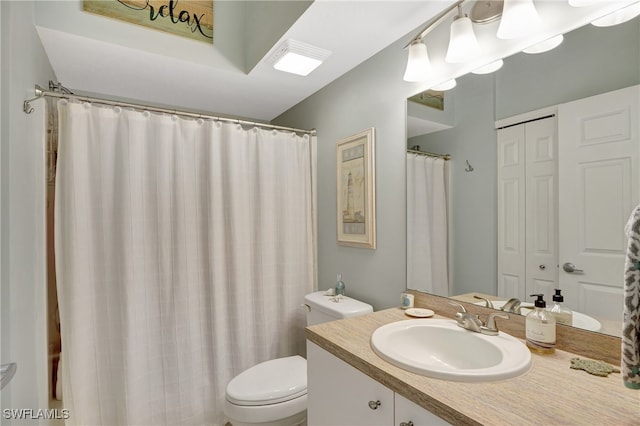 bathroom featuring walk in shower, toilet, and vanity