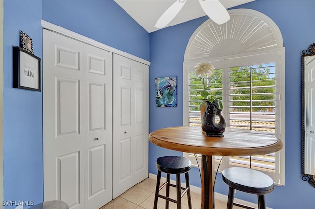 tiled dining area with ceiling fan