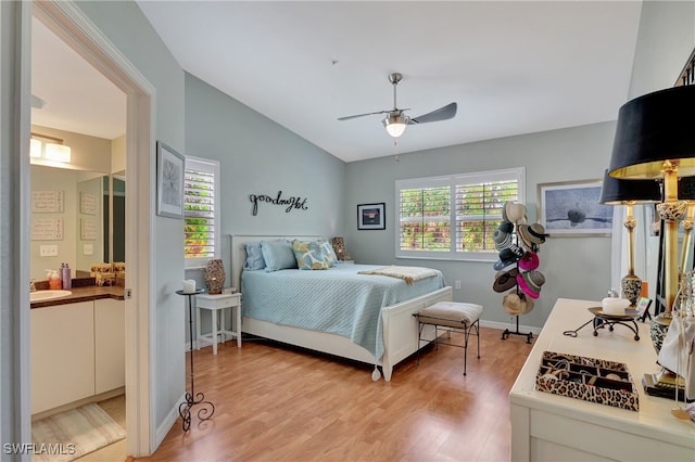 bedroom with multiple windows, hardwood / wood-style floors, sink, and ceiling fan