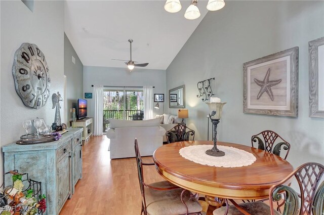 dining room with vaulted ceiling, light hardwood / wood-style flooring, and ceiling fan