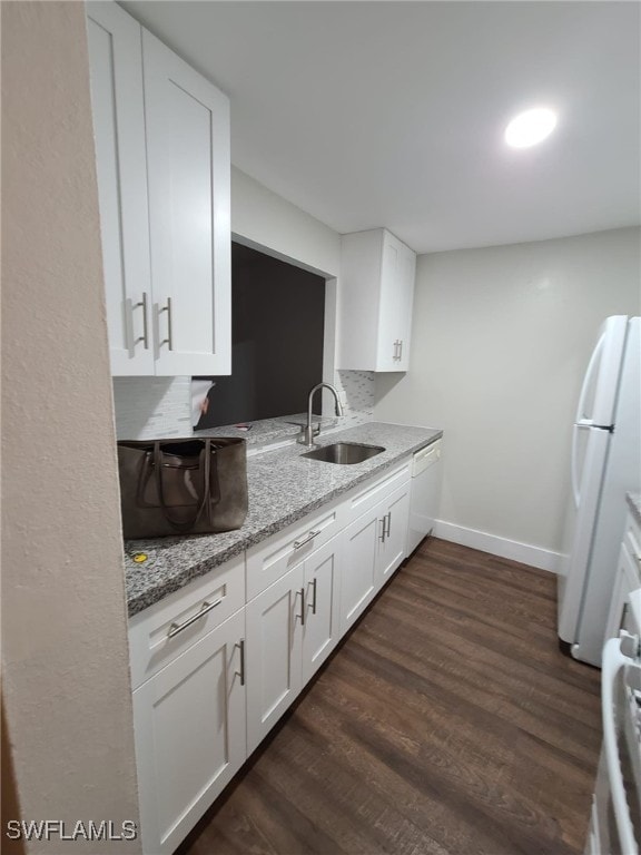 kitchen featuring white appliances, dark hardwood / wood-style flooring, sink, and white cabinets