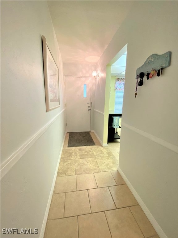 hall with light tile patterned flooring