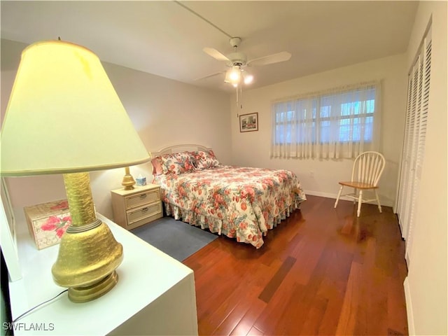 bedroom featuring ceiling fan, a closet, and wood finished floors