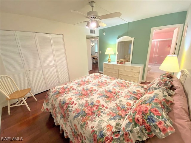 bedroom with a closet, visible vents, ensuite bathroom, ceiling fan, and wood finished floors