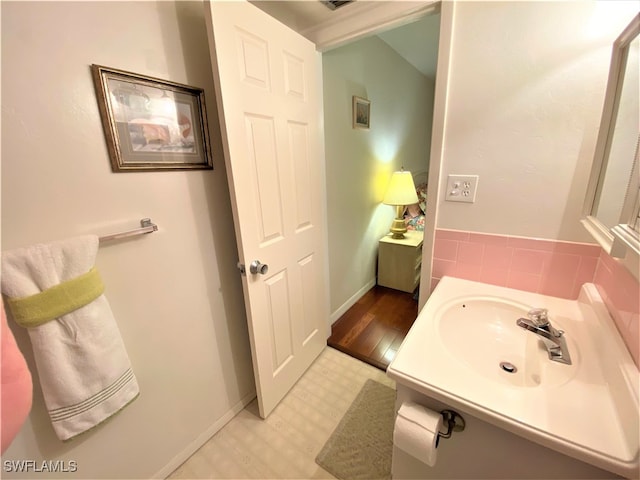 bathroom featuring wood-type flooring and sink