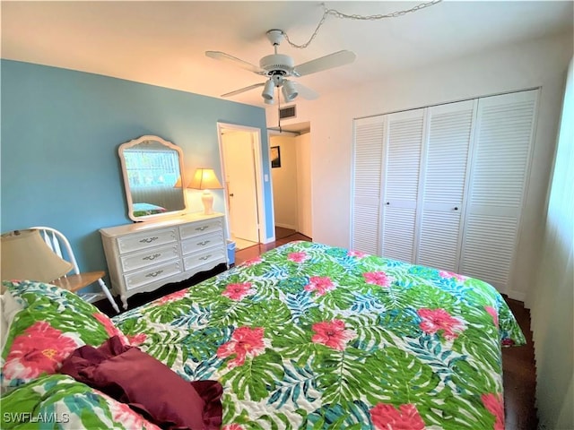 bedroom with ceiling fan, visible vents, and a closet