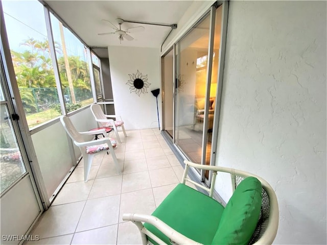 sunroom featuring a ceiling fan